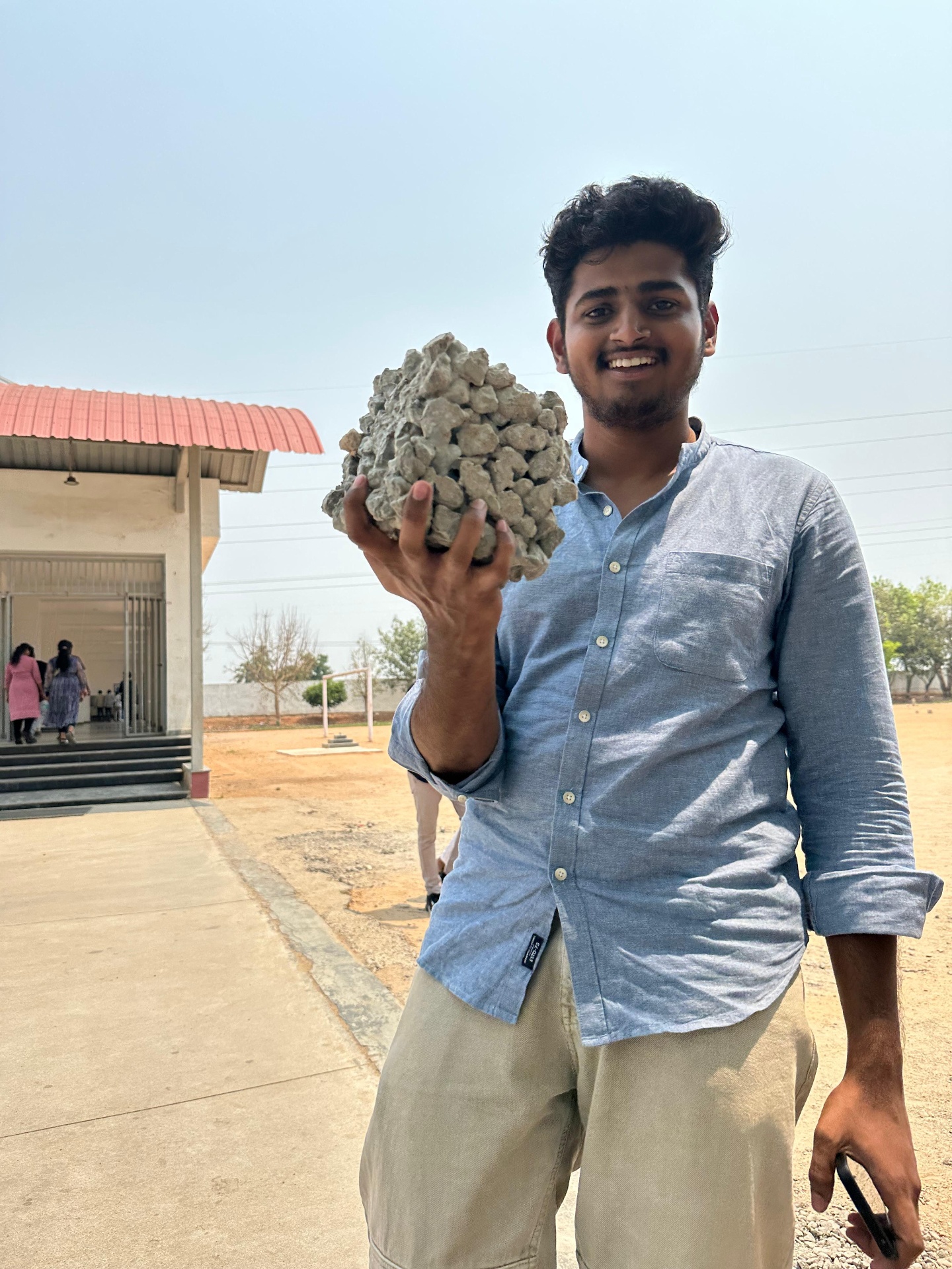Vedamsh holding a suspiciously large piece of concrete